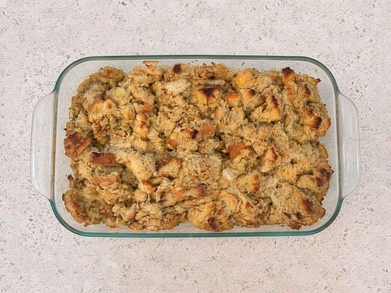 Golden baked turkey dressing in a glass baking dish